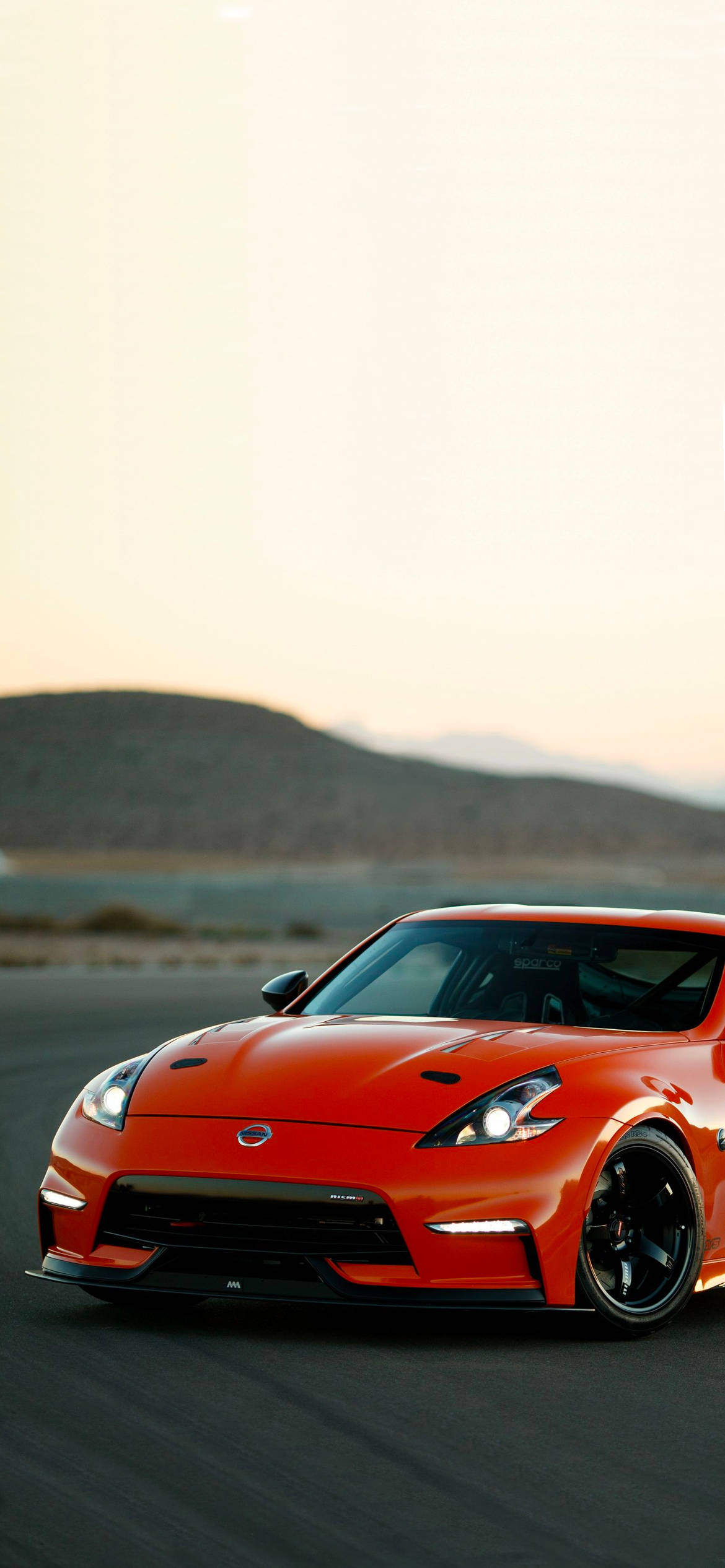 丘を背景にした赤い日産 370Z 壁紙