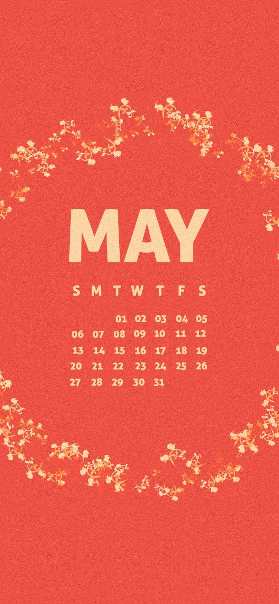 5月の美しさを祝う、鮮やかな花々が描かれた赤いカレンダー 壁紙