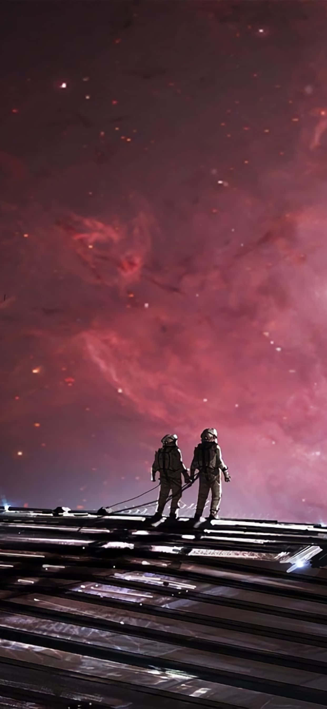 ピンクの空の線路を歩く2人の宇宙飛行士 壁紙
