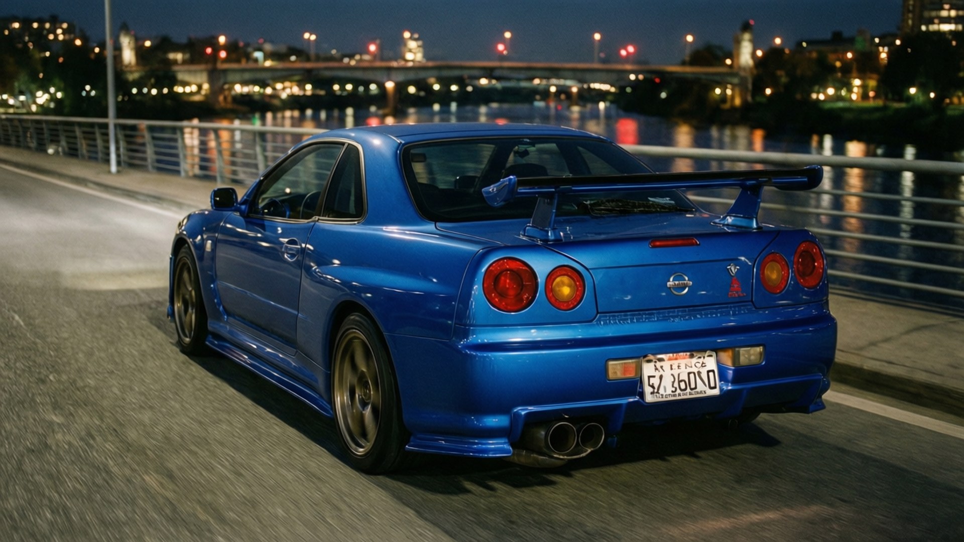 夜の橋の上に停まる青い日産GT-R。街の灯りが水面に反射している。