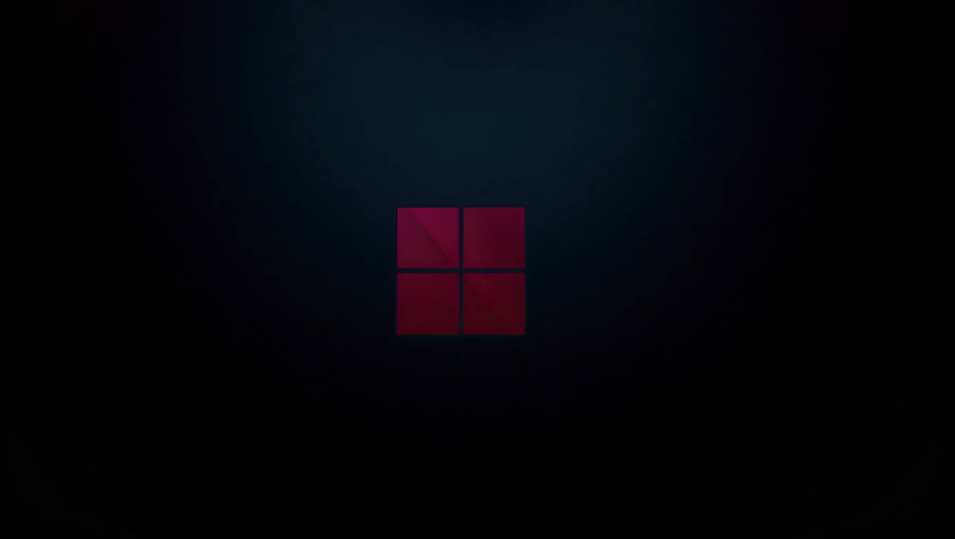 暗いノートPCのWindows 11ロゴ 壁紙