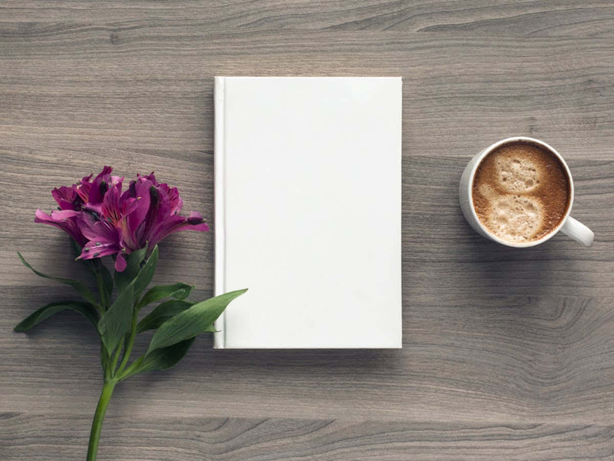 白い本と木のテーブルの上のコーヒーカップ 壁紙