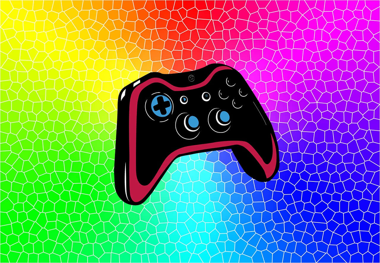虹色の背景に置かれたリモートゲームコントローラー 壁紙