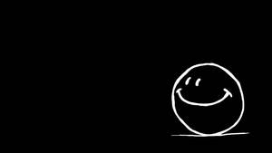 黒い背景に描かれたシンプルなスマイリーフェイスの壁紙