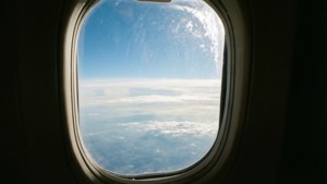 飛行機の窓から見える、雲と太陽の光が広がる空の景色。 — 空の眺め 壁紙